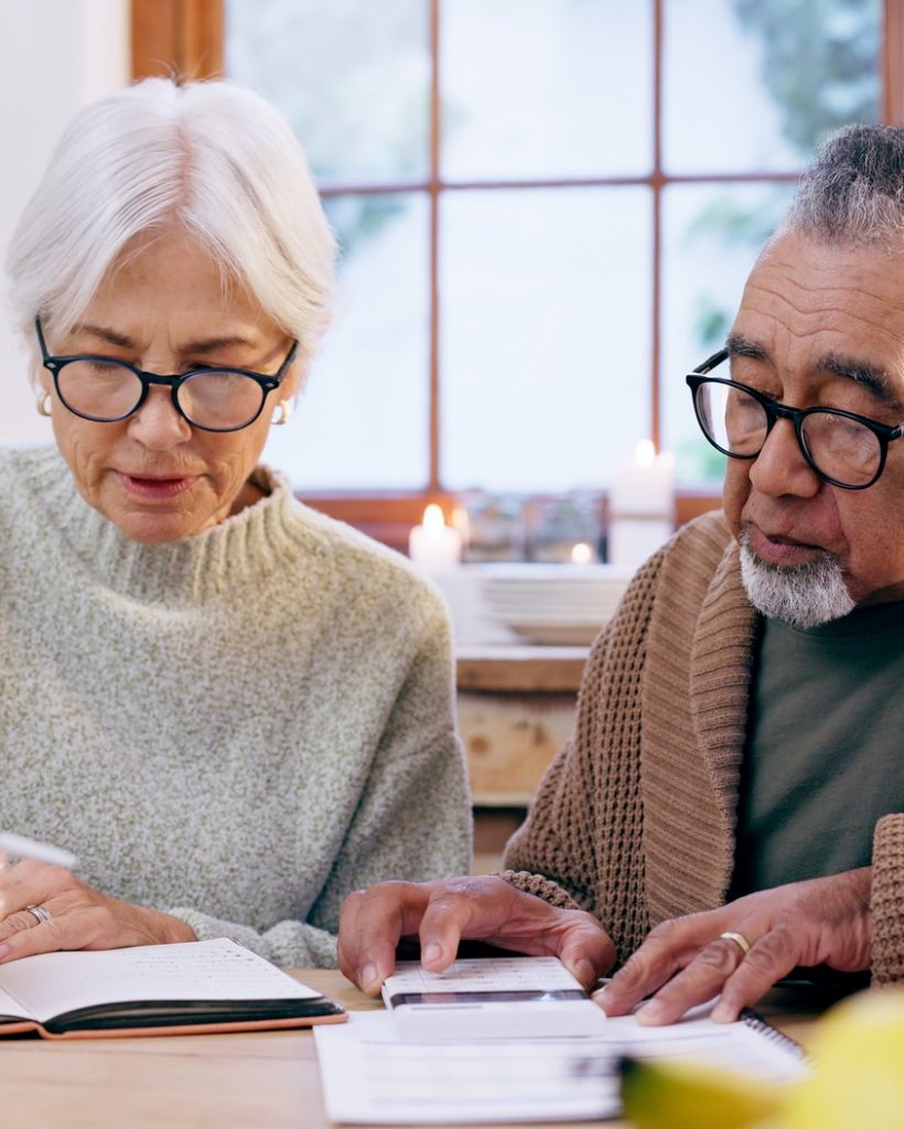 senior-couple-paperwork-and-contract-with-signature-and-life-insurance-information-for-will-and-po